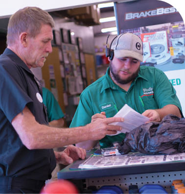 Two men are talking in a store. One man is wearing a hat. AI generated content