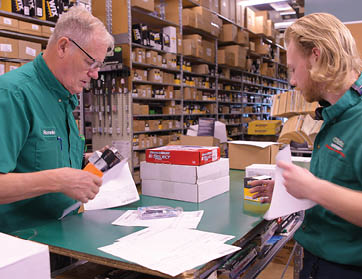 Two men are working in a warehouse, one of them is using a drill. AI generated content